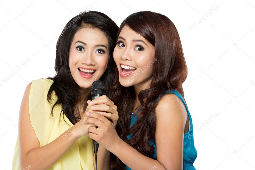 Two asian girls singing together