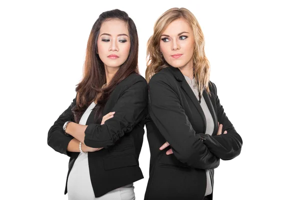 Two young businesswoman leaning againts each other, isolated — Stock Photo, Image