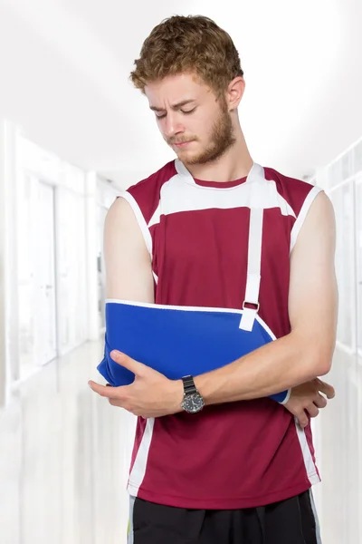 Sport man with arm in a sling — Stock Photo, Image