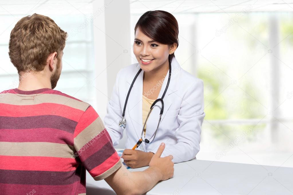 Smiling doctor giving a consultation to a patient in her medical