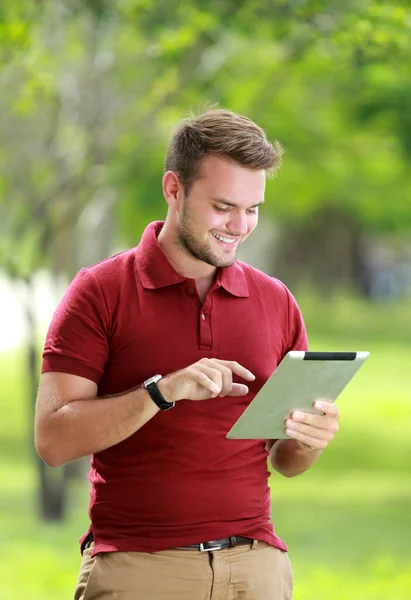 College student having fun playing a tablet — Stock Photo, Image