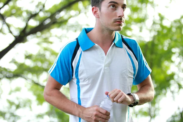 Sportieve mannelijke atleet nemen van een pauze na moe running — Stockfoto