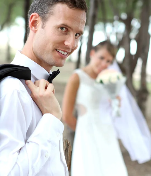 Stilig brudgummen leende och tittar på kameran — Stockfoto