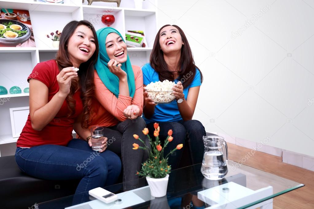 three beautiful women laughing together 