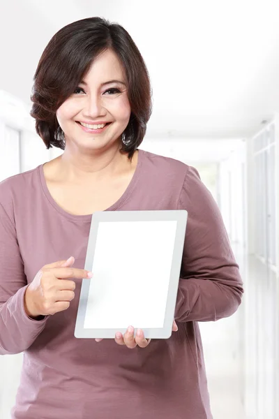 Kvinnan håller och visar tablet PC — Stockfoto