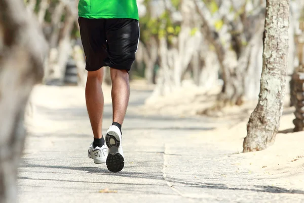 Mans foot running on the alley with trees alongside — Stock Photo, Image