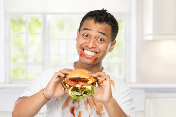Young man have a great desire to eat a burger — Stock Photo, Image