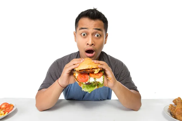 Young man have a great desire to eat a burger — Stock Photo, Image