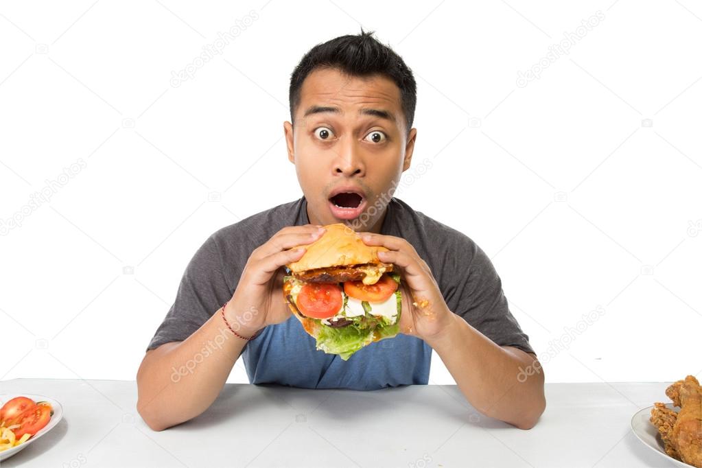 Young man have a great desire to eat a burger