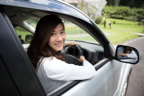 快乐年轻的亚裔女子骑着一辆车 — 图库照片