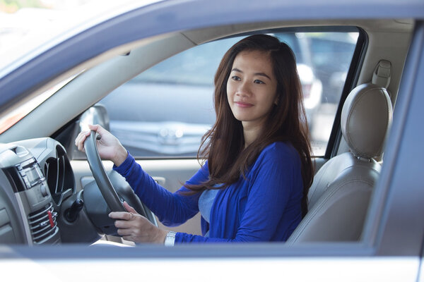 Young Asian woman on ride, a car.