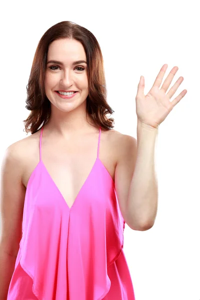 Woman smiling while waving hand — Stock Photo, Image