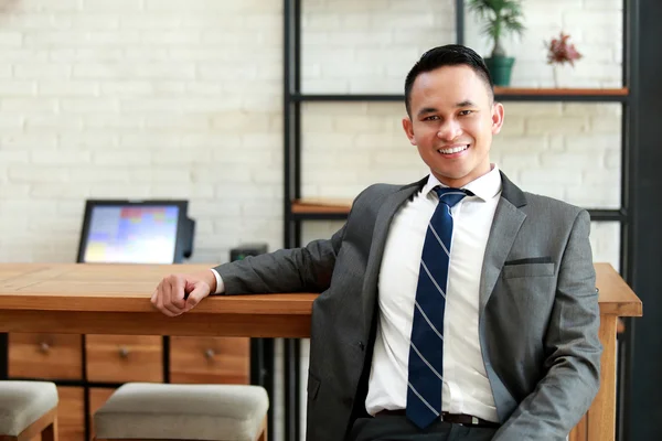 Businessman look relax sitting and smiling at coffee shop — Stock Photo, Image