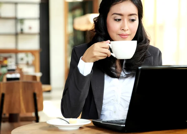 Επιχειρηματίας που εργάζεται για το laptop της κατά τη διάρκεια της διάλειμμα για καφέ — Φωτογραφία Αρχείου