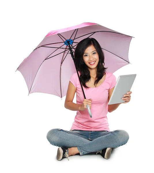 Mujer asiática sosteniendo un paraguas y una tableta PC mientras está sentado en — Foto de Stock