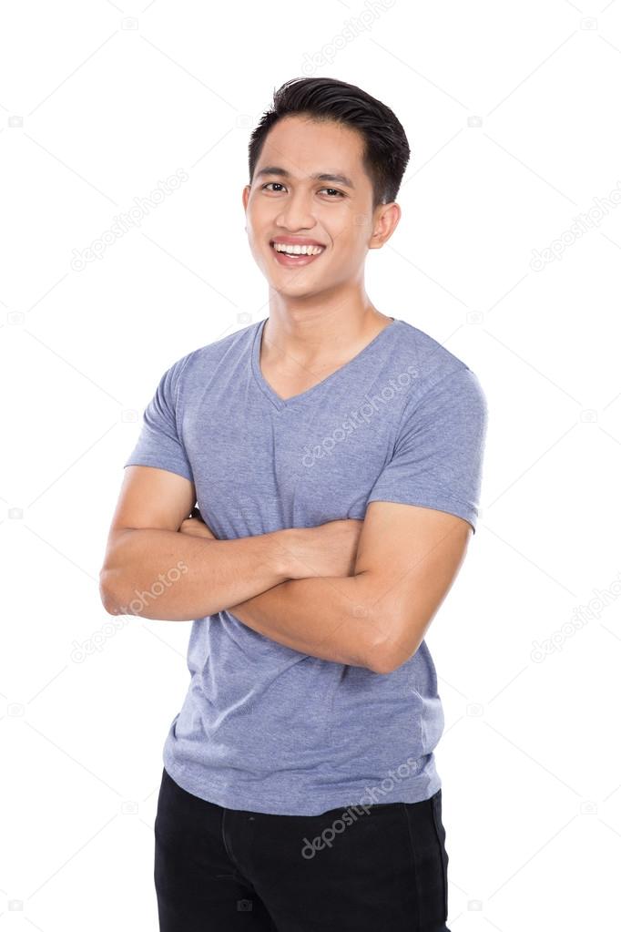 Young asian man posing on the white background, crossed arms