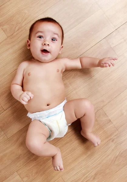 Adorable little baby lying on the floor — Stock Photo, Image