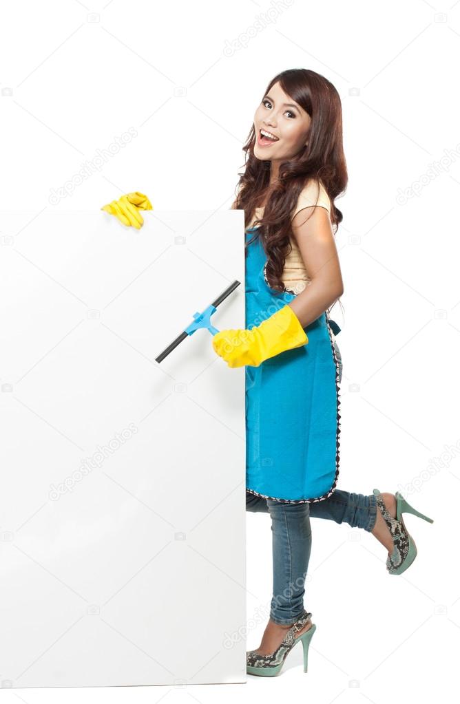 woman ready to do a domestic chores. standing next to white blan