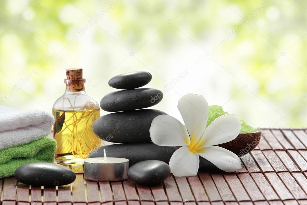 Essential oil , candle, towel and stones for teraphy