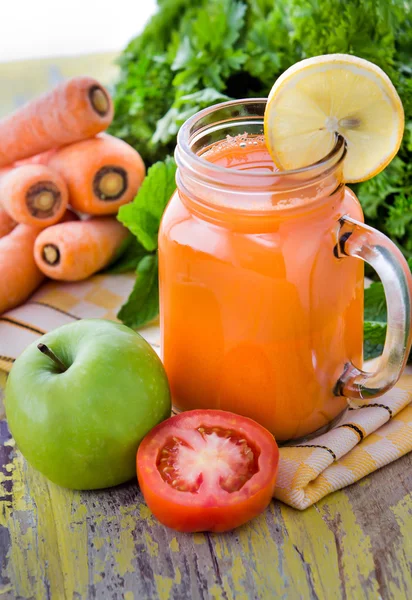 Um copo de maçã de mistura de cenoura e suco de tomate — Fotografia de Stock