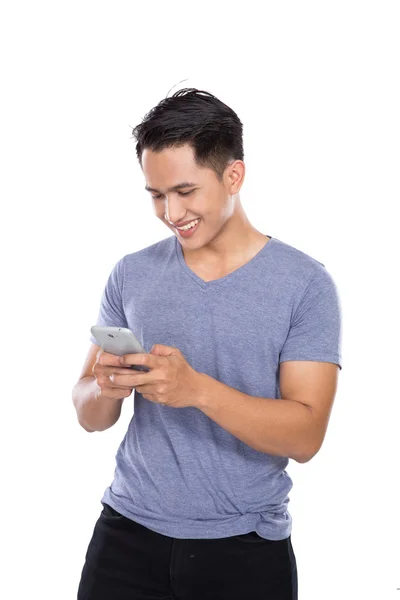 Asian young man holding a hanphone — Stock Photo, Image