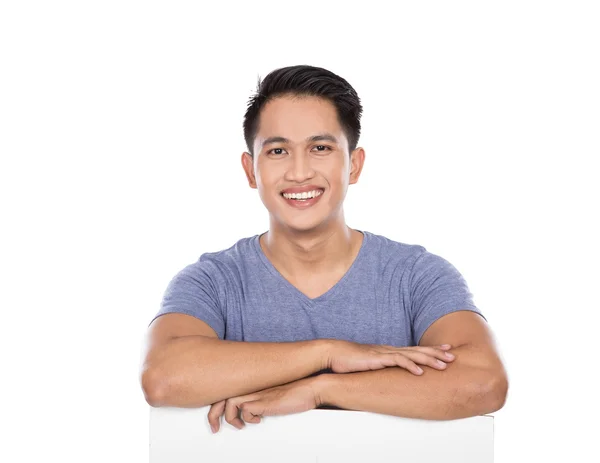 Young asian man holding a blank banner — Stock Photo, Image