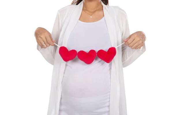 Asian pregnant woman posing with heart shape accessories on her — Stock Photo, Image