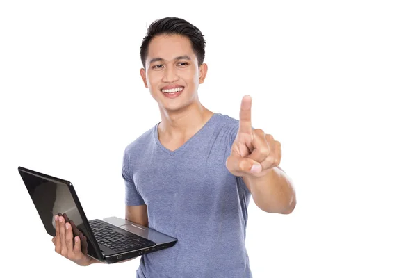 Young asian man standing with a laptop open, gesture of hand tou — Φωτογραφία Αρχείου