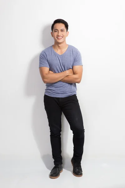 Young asian man leaning on white background, look at the camera — Zdjęcie stockowe