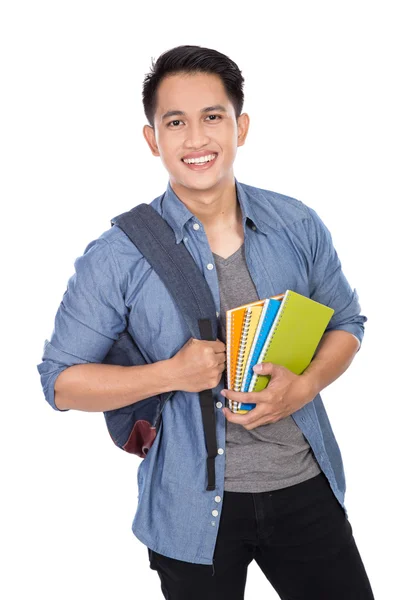 Jovem estudante asiático com uma mochila e segurando livros — Fotografia de Stock