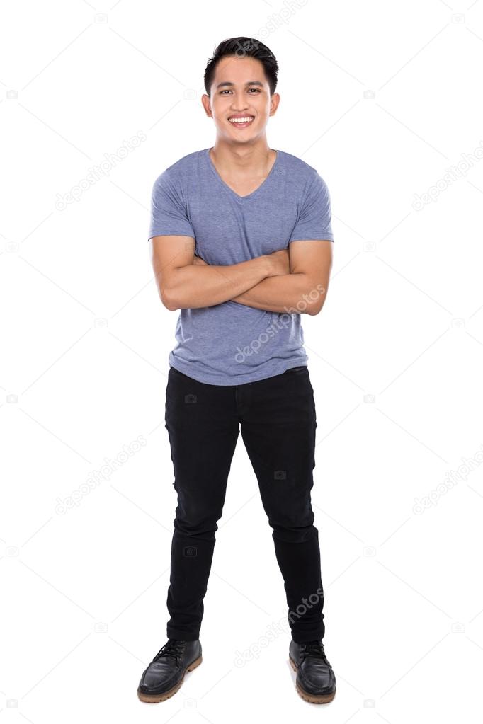 Young asian man posing on the white background, crossed arms