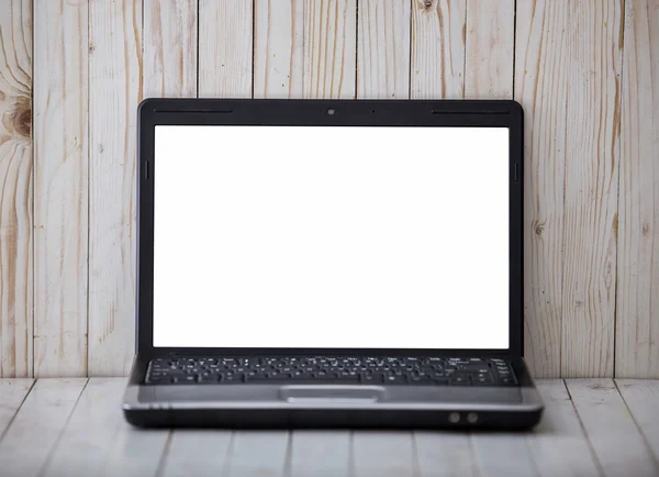 Black laptop on the wall and wooden background — Stock Photo, Image