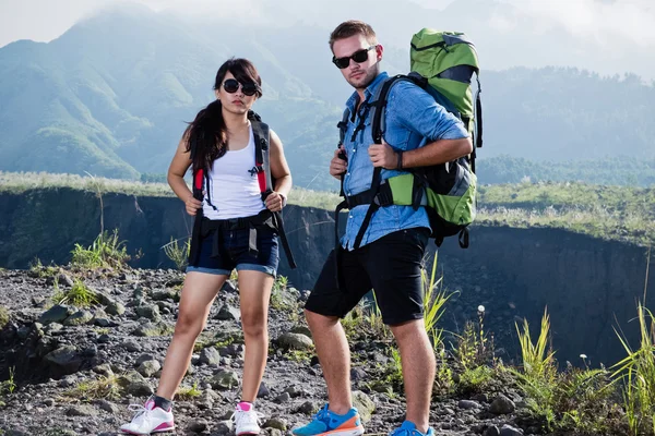 Jovem mulher e homem vão trekking juntos, natureza fundo — Fotografia de Stock