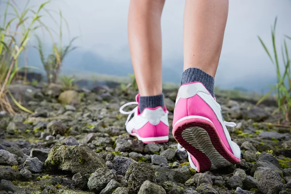 Trekking on the rocky road, foot close up — Stock Photo, Image