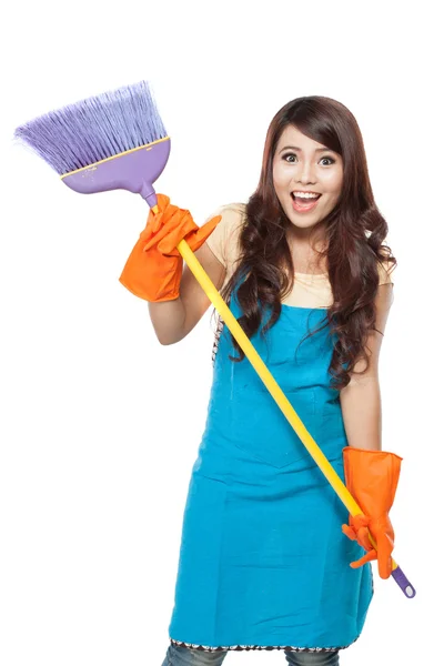 Beautiful young asian woman posing hold onto a broom, while smil — Stock Photo, Image