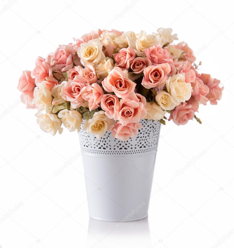A bunch of roses in white ceramic vase, isolated