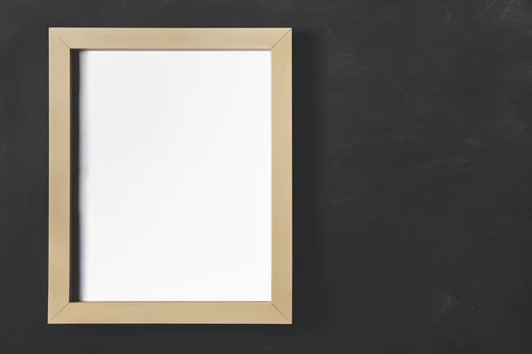 Empty wooden photo frame on black board for background — Stock Photo, Image