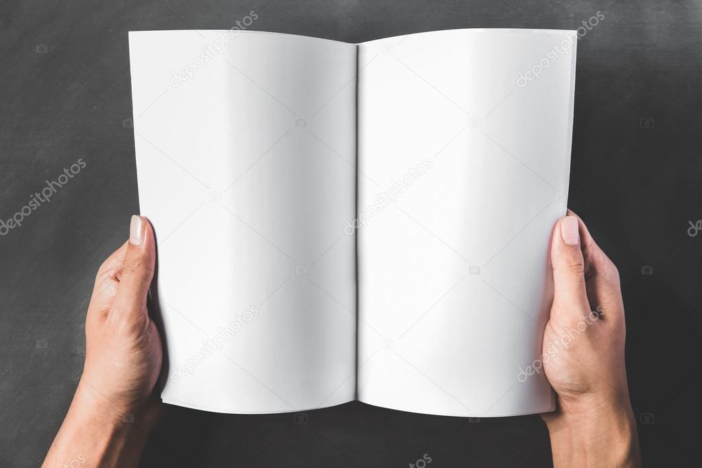 hands holding an open book with blank page — Stock Photo © odua 82781434