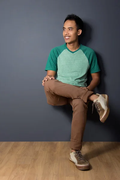 Young man sitting on invicible chair — Stock Photo, Image