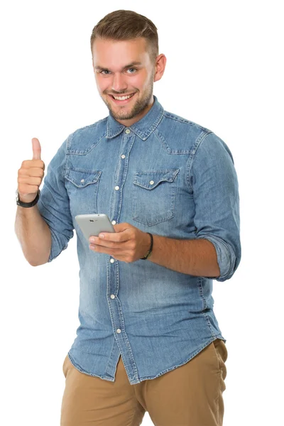 Joven sosteniendo un celular, pulgar hacia arriba — Foto de Stock