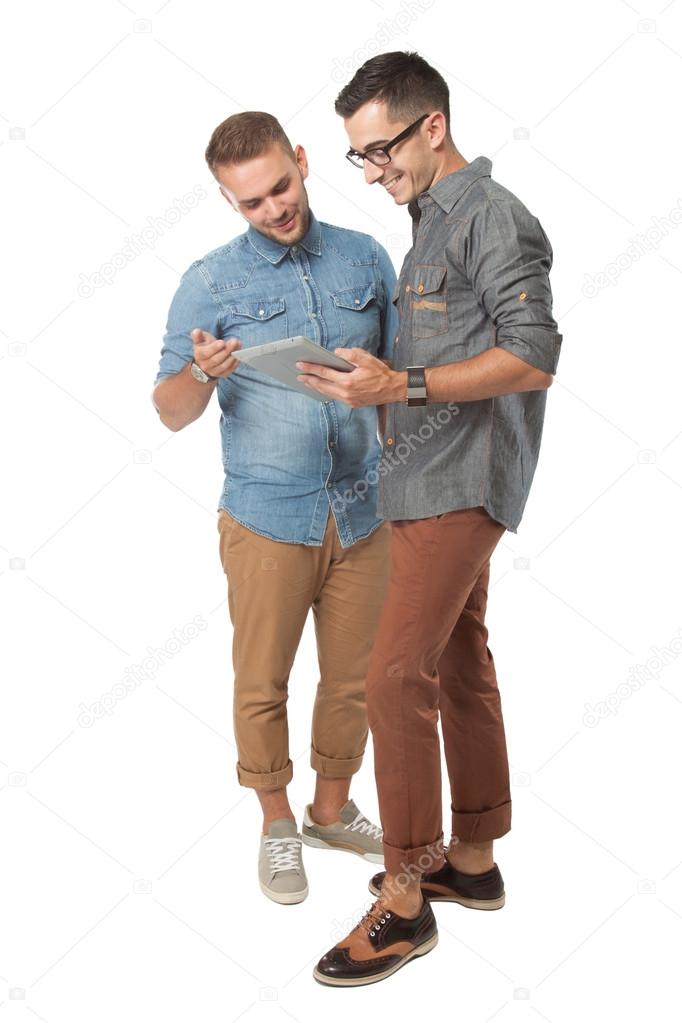 Two young man looking at a tablet pc, isolated