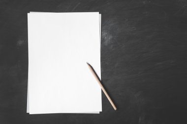 sheet piles of blank paper with pencil