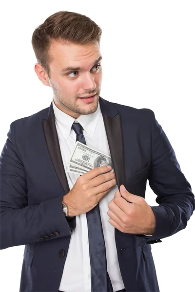 Businessman putting money into pocket — Stock Photo, Image