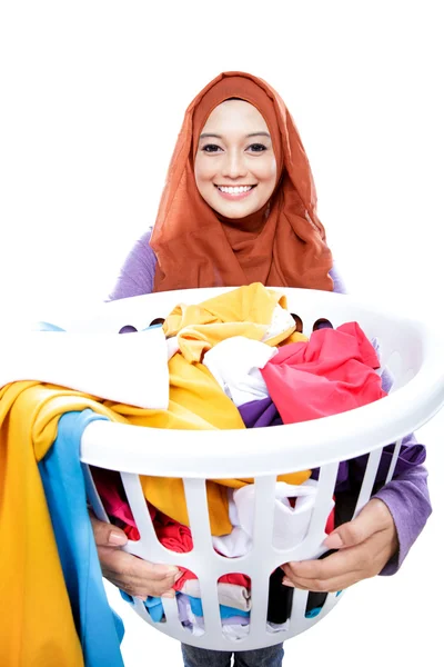 Housewife wearing hijab carrying laundry basket full of dirty cl — Stock Photo, Image