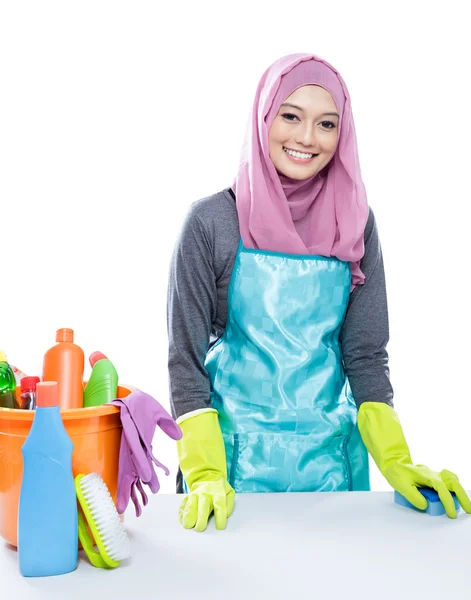 Young woman wearing hijab cleaning white table using sponge — ストック写真