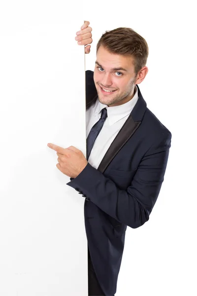 Businessman standing  next to a blank white billboard Royalty Free Stock Photos