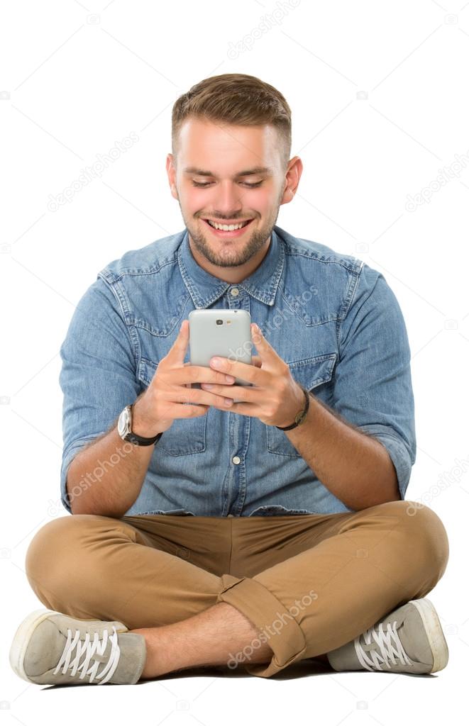 Young man reading something on his cellphone