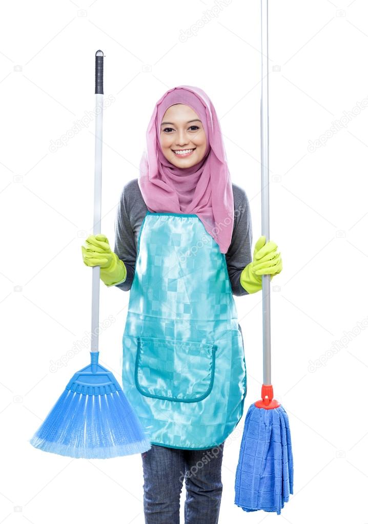 housewife wearing hijab holding broom and mop