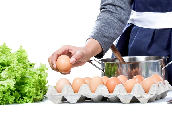 Hands of housewife pick up an egg preparing for making meal — Stockfoto