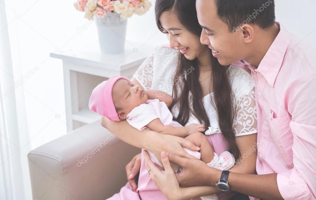 Couple looking at their baby girl